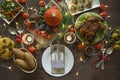 Thanksgiving dinner. Halloween dinner. Festive table with chicken and all side dishes, pumpkin, autumn leaves and seasonal autumn