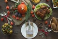 Thanksgiving dinner. Halloween dinner. Festive table with chicken and all side dishes, pumpkin, autumn leaves and seasonal autumn