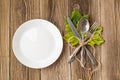 Thanksgiving dinner plate with fork, knife and autumn leaves on rustic wooden table background. Top view, copy space Royalty Free Stock Photo