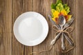 Thanksgiving dinner plate with fork, knife and autumn leaves on rustic wooden table background. Top view, copy space Royalty Free Stock Photo