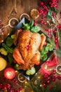 Thanksgiving Dinner. Roasted turkey, chicken. Winter Holiday table served, decorated. Candles and xmas baubles Royalty Free Stock Photo