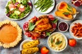 Thanksgiving dinner table with roasted whole chicken or turkey, green beans, mashed potatoes, cranberry sauce, grilled vegetables Royalty Free Stock Photo