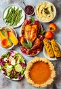 Thanksgiving dinner table with roasted whole chicken or turkey, green beans, mashed potatoes, cranberry sauce, grilled vegetables Royalty Free Stock Photo