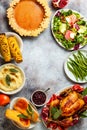 Thanksgiving dinner table with roasted whole chicken or turkey, green beans, mashed potatoes, cranberry sauce, grilled vegetables Royalty Free Stock Photo