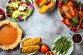 Thanksgiving dinner table with roasted whole chicken or turkey, green beans, mashed potatoes, cranberry sauce, grilled vegetables Royalty Free Stock Photo