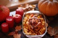 Thanksgiving Dinner. Thanksgiving table served with turkey, decorated with bright autumn leaves. Royalty Free Stock Photo