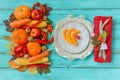 Autumn table setting, menu composition, vintage cutlery, sliced pumpkin. Royalty Free Stock Photo