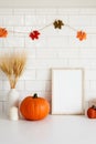 Thanksgiving frame mockup with pumpkins, vase of wheat, garland of leaves on tile wall background