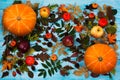 Thanksgiving greeting with fall leaves and pumpkin on blue background Royalty Free Stock Photo