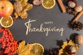 Thanksgiving greetings. Dry leaves, nuts and spices on a dark background, top view. Kaligraphic capital inscription Royalty Free Stock Photo