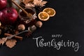 Thanksgiving greetings. Honey, dry leaves, apples and spices on a dark background, top view. Kaligraphic capital inscription Royalty Free Stock Photo