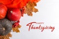 Thanksgiving greetings. Pumpkins, dry leaves on a white background, top view. Kaligraphic capital inscription Royalty Free Stock Photo