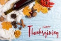 Thanksgiving greetings. Set for mulled wine, wine, spices, leaves, cones, scarf on a blue background, top view. Kaligraphic Royalty Free Stock Photo