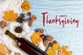 Thanksgiving greetings. Set for mulled wine, wine, spices, leaves, cones, scarf on a blue background, top view. Kaligraphic Royalty Free Stock Photo