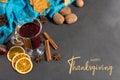 Thanksgiving greetings. Set for mulled wine, wine, spices, leaves, cones, scarf on a gray background, top view. Kaligraphic Royalty Free Stock Photo