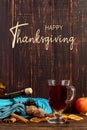 Thanksgiving greetings. Set for mulled wine, wine, spices, leaves, cones, scarf on wooden background, top view. Kaligraphic Royalty Free Stock Photo