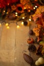 Thanksgiving or Halloween, Autumn composition with dry leaves and small pumpkins on an old wooden table with glowing lights. View