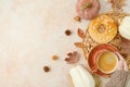 Thanksgiving holiday background with coffee cup, cookie, white pumpkin and woman`s hand n warm sweater. Top view, flat lay