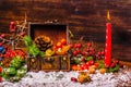 Thanksgiving holiday background with opened chest treasure, apple, nuts, cones, berries, fir tree, candle and snow, close up Royalty Free Stock Photo