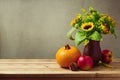 Thanksgiving holiday table decoration with sunflowers, pumpkin and apples Royalty Free Stock Photo