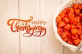 Thanksgiving - Lettering. Autumn background. Bright orange physalis berries on a brown woody background. Background for the autumn