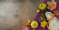 Thanksgiving party banner concept with plate, pumpkin and autumn leaves on dark background. Top view, flat lay