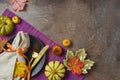 Thanksgiving party concept with plate, pumpkin and autumn leaves on dark background. Top view, flat lay