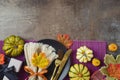 Thanksgiving party concept with plate, pumpkin and autumn leaves on dark background. Top view, flat lay