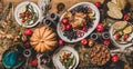 Thanksgiving party table setting with roasted chicken seasonal produce Royalty Free Stock Photo