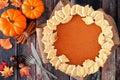 Thanksgiving pumpkin pie with autumn leaf pastry design, overhead scene on rustic wood Royalty Free Stock Photo