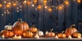 Thanksgiving pumpkins on rustic table with candles and string lights