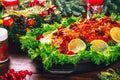 Thanksgiving table served with baked meats, decorated with bright Christmas decor and candles. Christmas dinner with roasted pork Royalty Free Stock Photo