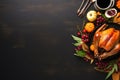 Thanksgiving table setting with roasted turkey on black wooden background. Top view with copy space Royalty Free Stock Photo