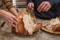 Thanksgiving traditional turkey preparation. Man cuts roasted turkey meat. Thanksgiving diner Royalty Free Stock Photo