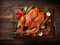 Thanksgiving turkey background, close up. Roasted turkey garnished with vegetables and herbs on wooden table. Festive dish served Royalty Free Stock Photo