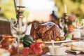 Thanksgiving turkey, food and table set for lunch outdoors with wine glasses. Champagne glasses, fine dining, and Royalty Free Stock Photo