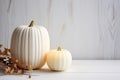 Thanksgiving White Pumpkin And Candle Decorations On White Painted Wood Table