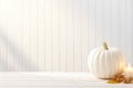 Thanksgiving white pumpkin and candle decorations on a white painted wood table. Halloween, Thanksgiving party concept