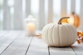 Thanksgiving white pumpkin and candle decorations on a white painted wood table. Halloween, Thanksgiving party concept