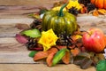 Thanksgiving wreath with green pumpkin, apple, yellow silk roses Royalty Free Stock Photo