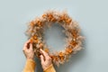 Thanksgiving wreath with orange flowers and dry natural materials isolated over white bakground. Top view. Royalty Free Stock Photo