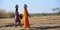 Rajasthani women carrying water jars in the head. Royalty Free Stock Photo