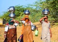 Rajasthani women carrying water jars in the head. Royalty Free Stock Photo