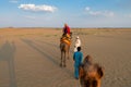 Thar desert, Rajasthan, India- 15.10.2019 : Female tourist riding camel, Camelus dromedarius, at sand dunes of Thar desert, Royalty Free Stock Photo