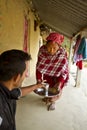 Tharu woman offering tea to her husband, Bardia, Nepal Royalty Free Stock Photo