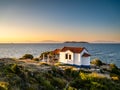 Thasos island at sunrise with blue waters and beautiful small white church greek style Royalty Free Stock Photo