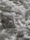 Thassos, Greece, August 18: Close up of sea water and pebbles, texture backdrop, detail of wave