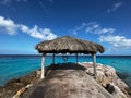 Thatch beach hut with a heart decoration hanging from it on the view of the ocean waves Royalty Free Stock Photo