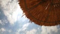 Thatched Beach Umbrella Under Cloudy Sky