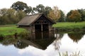 Thatched boathouse at River Avon bank, Warwick castle garden, England Royalty Free Stock Photo